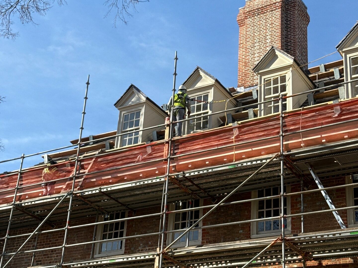 Sun Painting crew on scaffolding restoring the roofline of the Wren Building at William & Mary